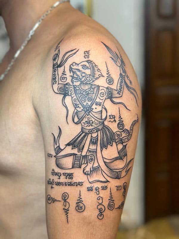 Arm tattoo of Hanuman in Sak Yant style