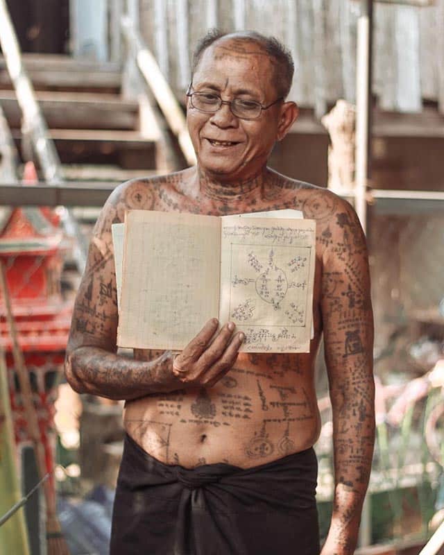 Sak Yant master showing a traditional tattoo design